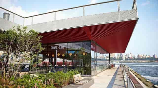 Waterfront venue with glass frontage, perfect for corporate events and sunset networking.
