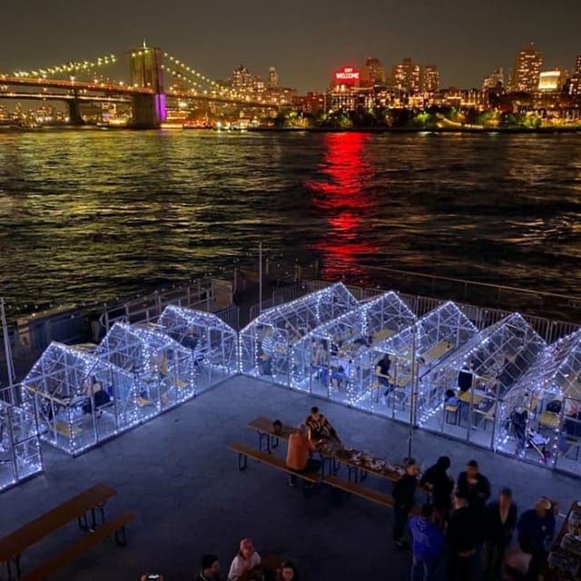 Waterfront pop-up dining with illuminated igloos for private events and outdoor corporate functions.