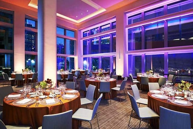 Conrad New York Downtown gala room with floor-to-ceiling windows for corporate events and banquets.