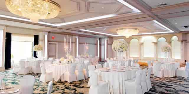 Upscale ballroom event setup with floral centerpieces for a luxury gala or wedding reception.