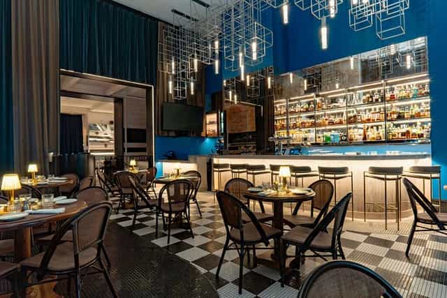 Sophisticated NYC rooftop lounge with geometric lighting for corporate receptions and cocktail hours.