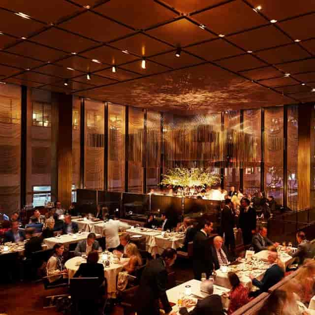 Sophisticated restaurant with ambient lighting for premium corporate dining and networking events.