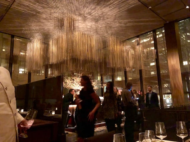 Networking reception at The Salon featuring dramatic oversized lighting for corporate events.