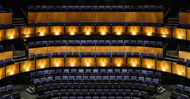 Tiered theatre at Kingbridge Centre with atmospheric lighting for presentations and keynotes.