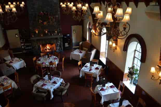 Stone fireplace dining room at The Stone House for boutique events and corporate board dinners.