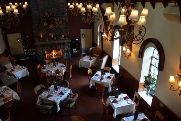 Stone fireplace dining room at The Stone House for boutique events and corporate board dinners.