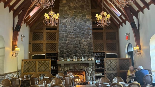 Stone House Fireplace Room: Rustic event venue with stone hearth for corporate retreats and dinners.