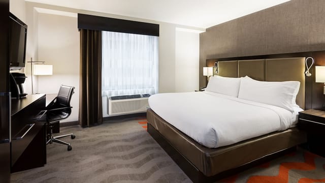 Modern guestroom at Holiday Inn NYC Lower East Side for corporate conferences and business travel.