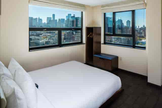 Minimalist Orchard Street Hotel rooftop room with city view for event lodging and corporate stays.