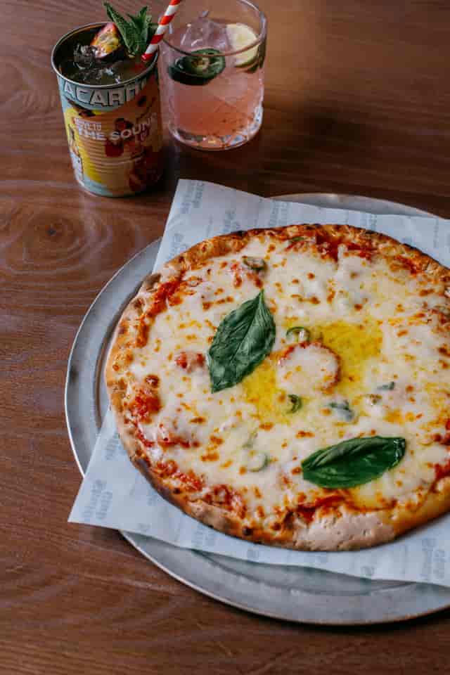 Freshly baked pizza with golden crust at Shuffle Club for events and gatherings.