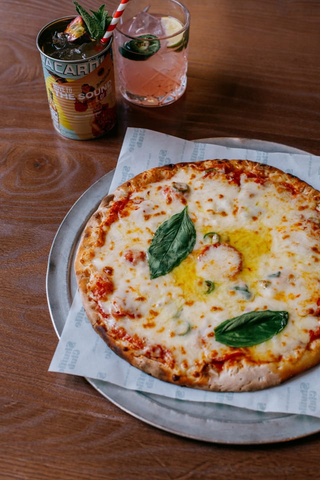 Freshly baked pizza with golden crust at Shuffle Club for events and gatherings.