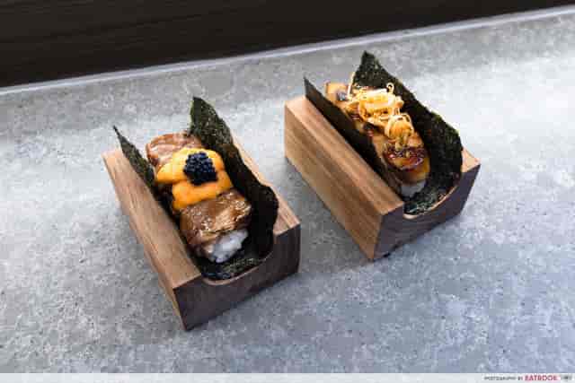 Individual portioned appetizers on wooden platter for cocktail reception catering.