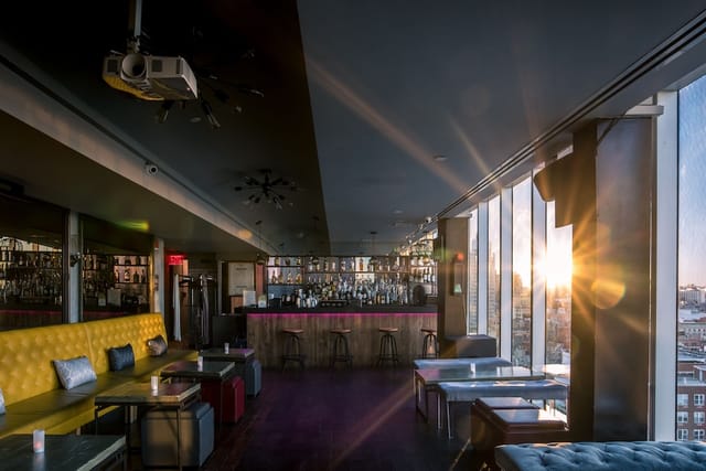 Sun-drenched Rooftop 93 bar, ideal for upscale corporate cocktail receptions and networking events.