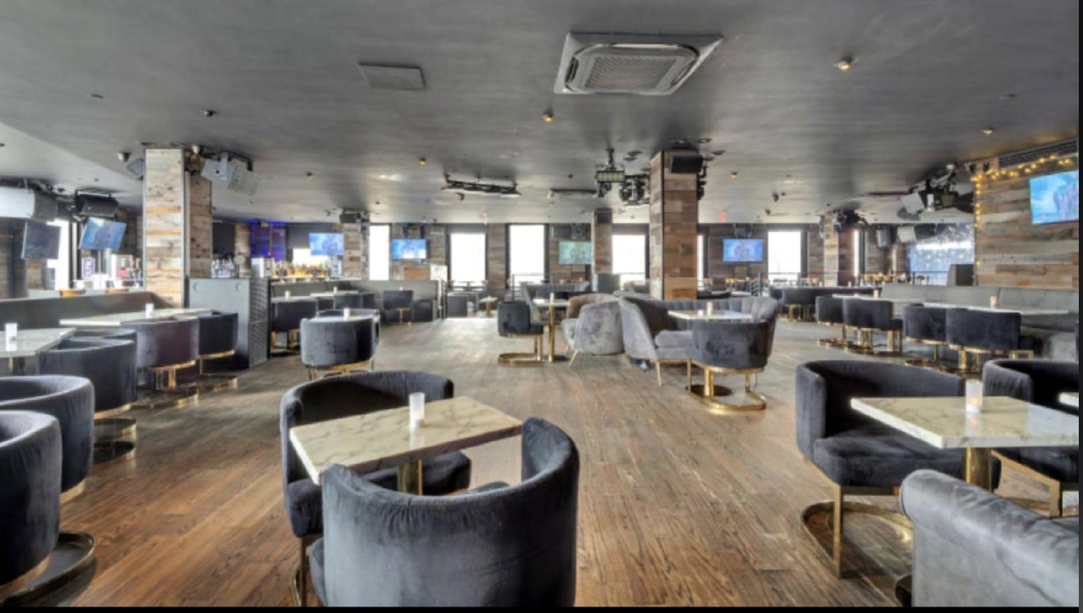 Modern event space at The Hard Bar, featuring plush seating for cocktail receptions.