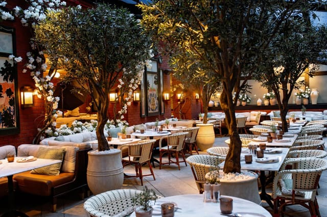 Fouquet's New York brasserie with greenery for upscale networking and premium seated dinner events.