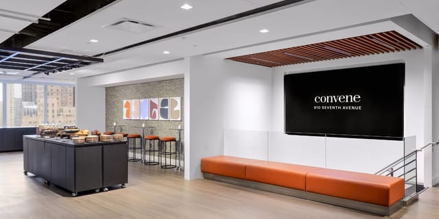 Modern meeting room with digital display for corporate networking and business event catering.