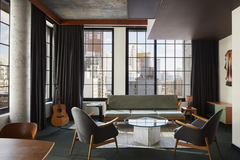 Industrial-chic Brooklyn Hotel suite for VIP meetings and brainstorming sessions with city views.