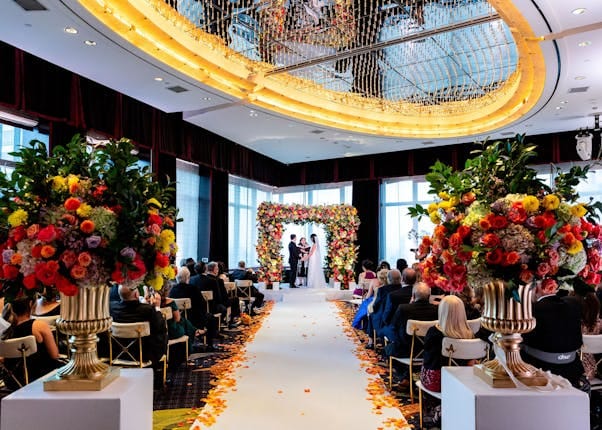 Luxury wedding ceremony at Mandarin Oriental New York with elegant floral arch and aisle decor.
