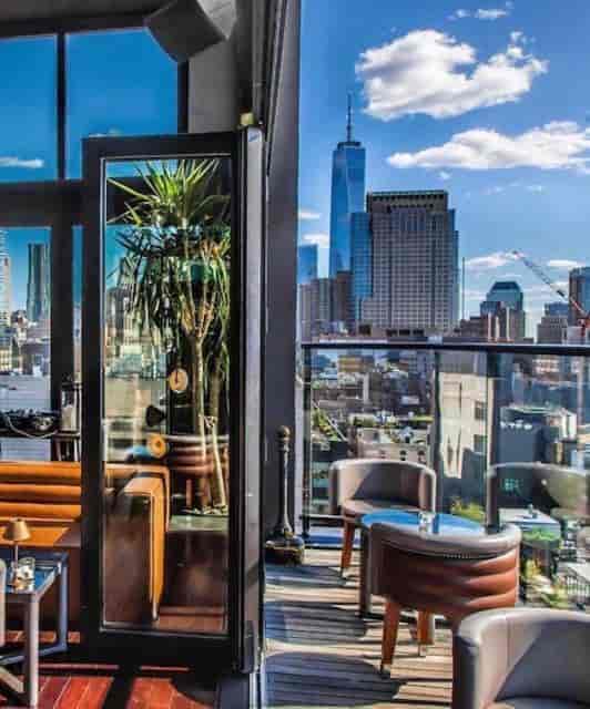 Hotel Hugo NYC rooftop cocktail reception with skyline view for corporate networking events.