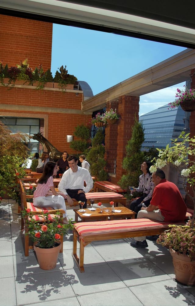 Hotel Giraffe rooftop garden venue featuring lush landscaping for corporate networking events.