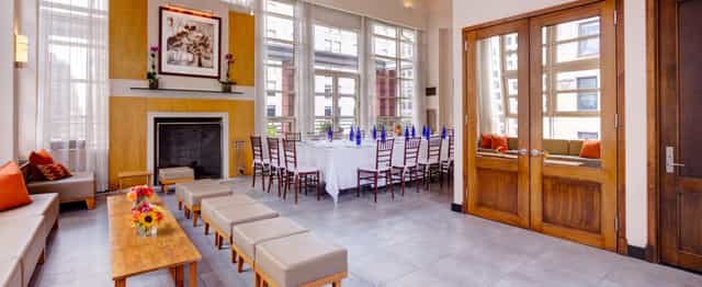 Corporate boardroom at Hotel Giraffe featuring a fireplace, ideal for executive meetings or events.