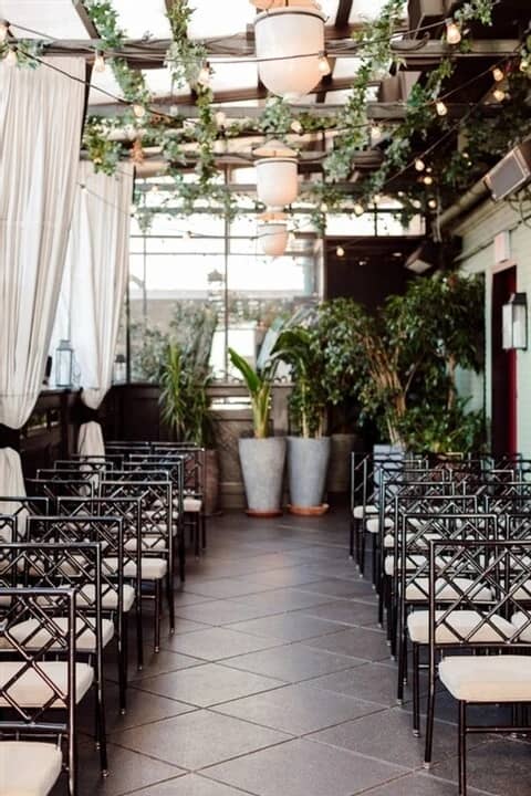 Chic rooftop terrace with bamboo chairs, perfect for boutique wedding or corporate event.