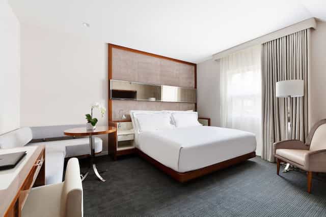 Signature Suite guest room with dedicated workspace for corporate travel and hotel room blocks.