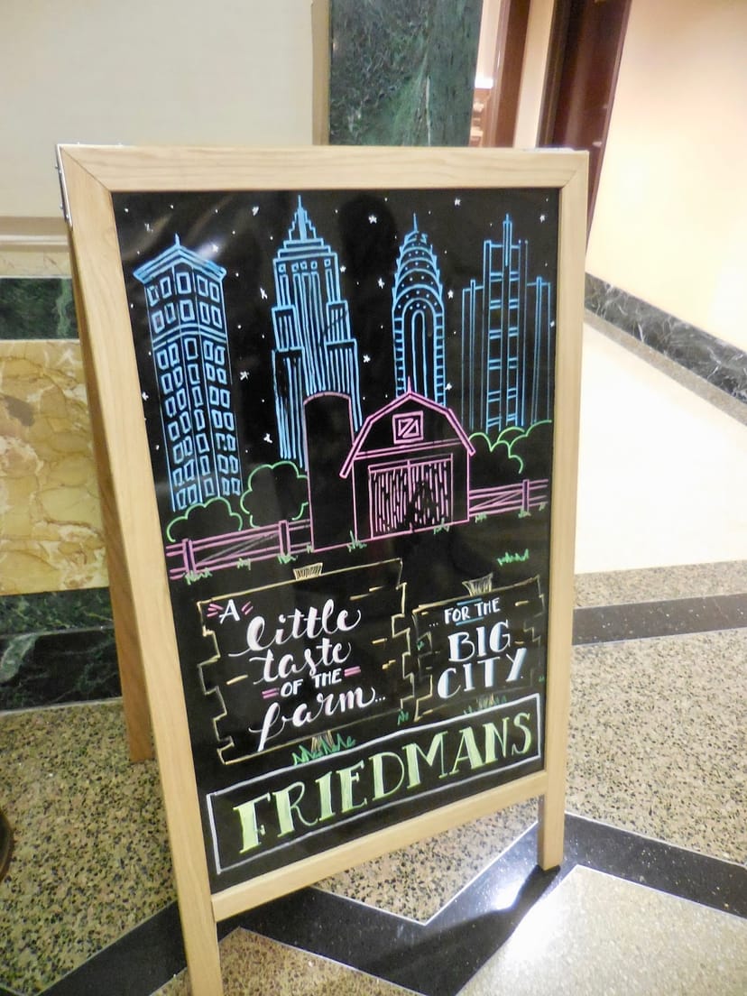 Friedman's Hotel Edison A-frame chalkboard sign for farm-to-table event promotion.