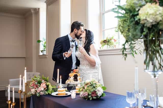 Bridal suite cake cutting at Shea's Seneca featuring elegant floral decor for intimate weddings.