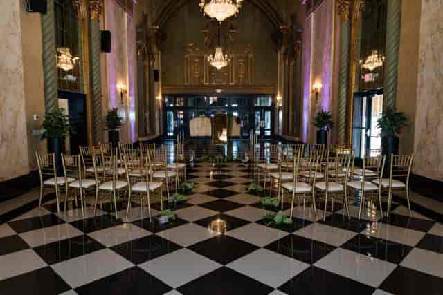 Bridal suite ceremony setup with gold chairs and purple lighting for wedding venue events.