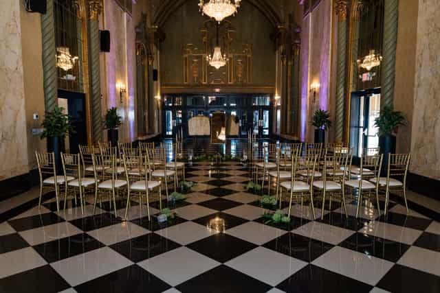 Bridal suite ceremony setup with gold chairs and purple lighting for wedding venue events.