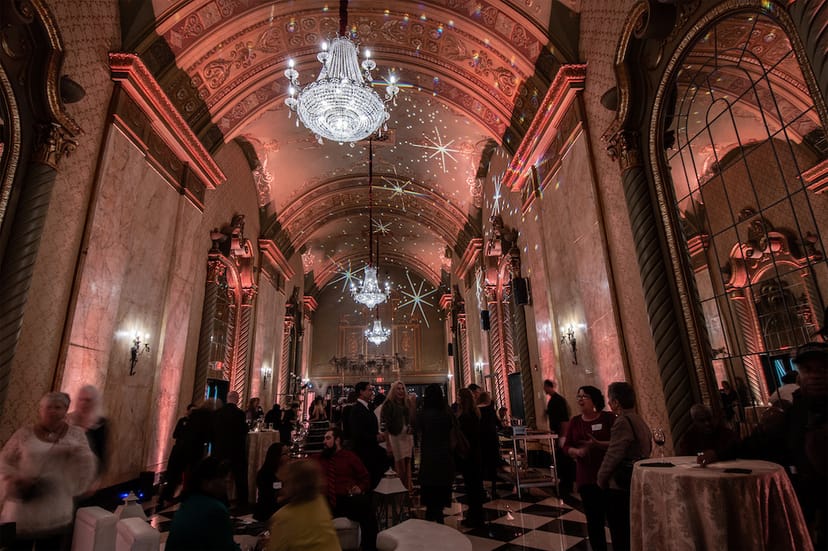 Main ballroom at Shea's Seneca with dramatic lighting for elegant wedding and corporate events.