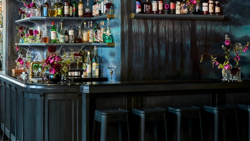 Moody La Mercerie cocktail bar with floral decor for VIP networking and upscale receptions.