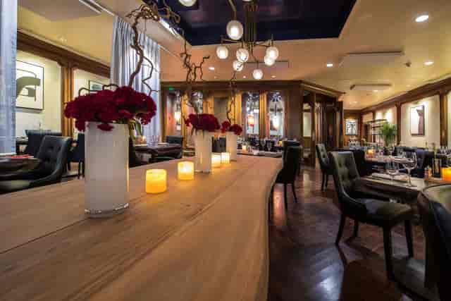 Garden City Hotel Lobby Lounge: upscale venue with wood table for corporate events and dinners.