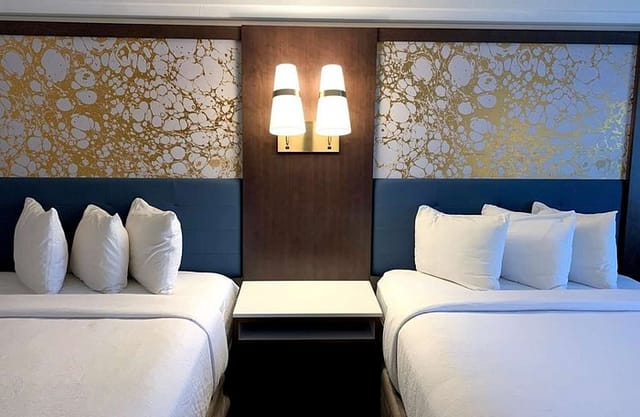 Double-queen hotel room at The Hub Murray Hill for corporate lodging and event room blocks.