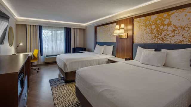 Modern guest room with double queens at The Hub Murray Hill for group hotel blocks.