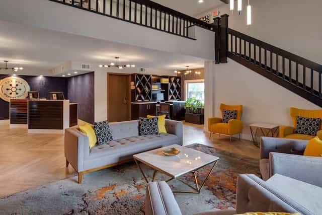 Modern meeting room at The Hub Murray Hill featuring flexible lounge seating for networking events.