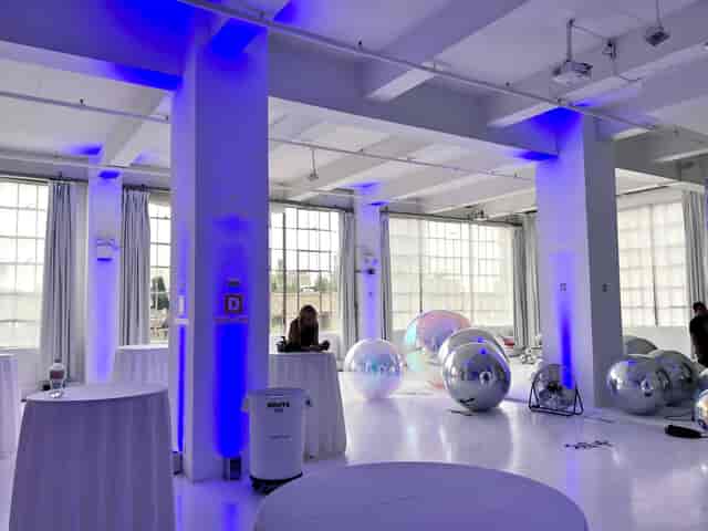 Loft 10 industrial event space with blue uplighting for modern corporate event or wedding venue.