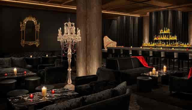 Luxury VIP lounge with moody lighting for high-end corporate networking and evening events.