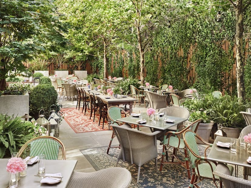 Outdoor garden venue with lush landscaping for corporate luncheon and networking events.