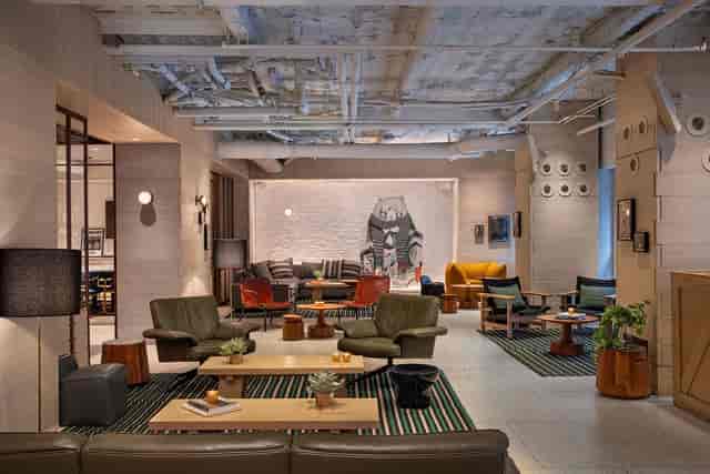 Industrial-chic Concorde Hotel lobby lounge for corporate networking and VIP event breakout spaces.