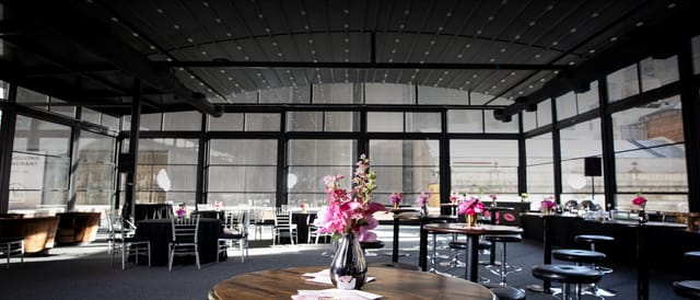 Modern industrial rooftop venue with retractable roof for corporate galas and cocktail events.