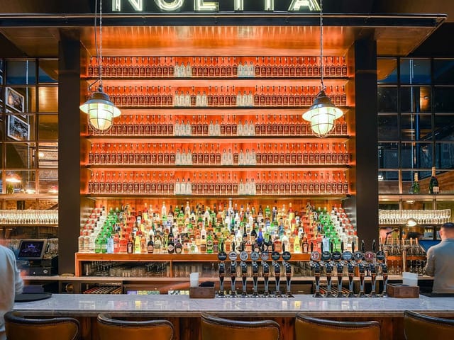 Whiskey Bar & Balcony in NoLita: statement bar backdrop for evening receptions and large events.
