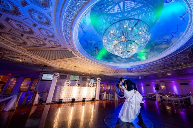 Floral Terrace wedding reception with grand chandelier and event lighting.
