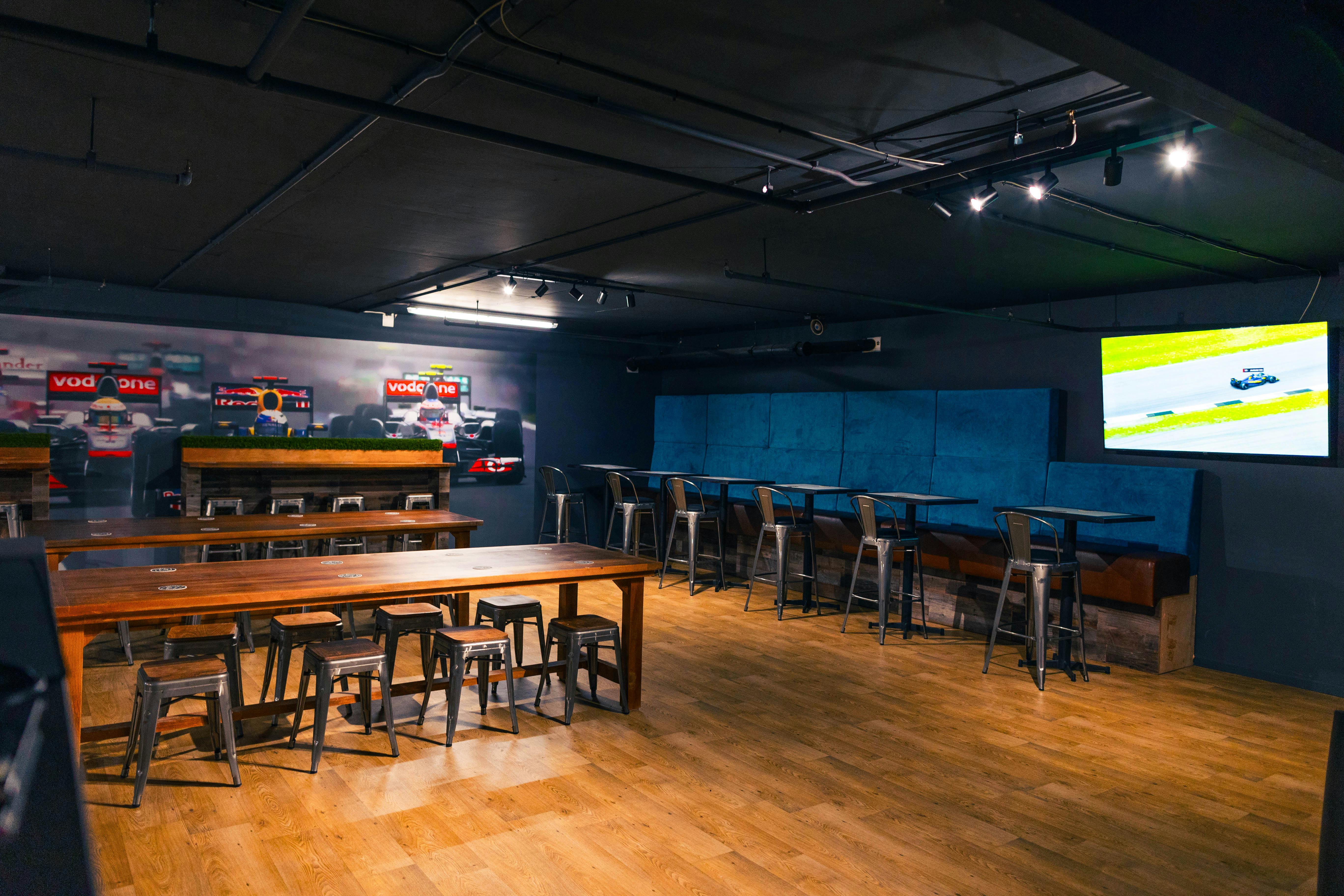 Indoor karting event space with communal tables, ideal for networking and team-building.