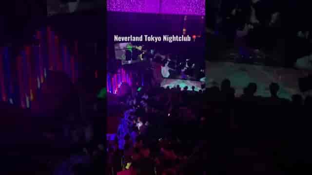 Crowded Club Neverland Tokyo nightclub with vibrant neon lighting for nightlife and club events.