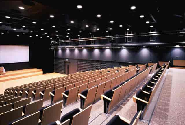 Modern AP Marunouchi auditorium with professional stage lighting for corporate keynote events.