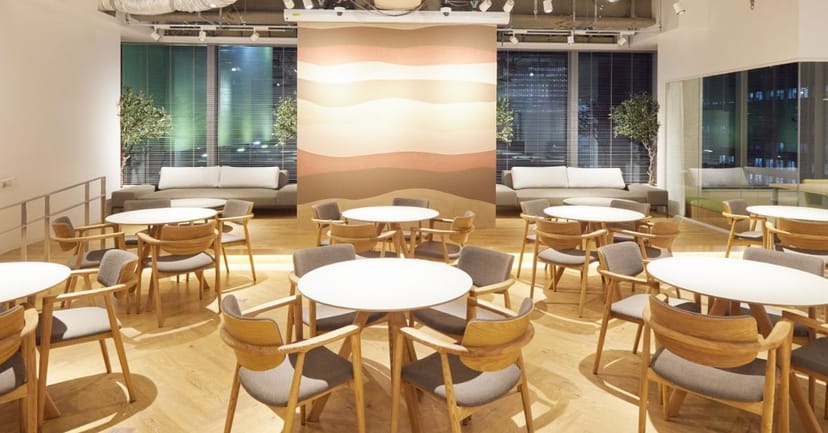 Modern breakout space at AP Tokyo Yaesu with circular seating for workshops and networking.