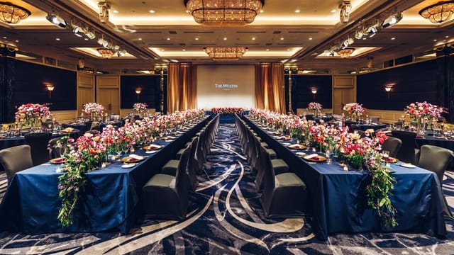 Luxury gala dinner setup at The Westin Tokyo conference hall with floral centerpieces.