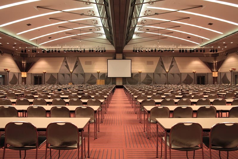 Makuhari Messe conference hall set for a training seminar or corporate plenary session.